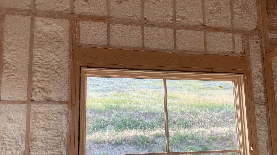 New wall insulation installed around a window in a Montana home by Olympus Insulation